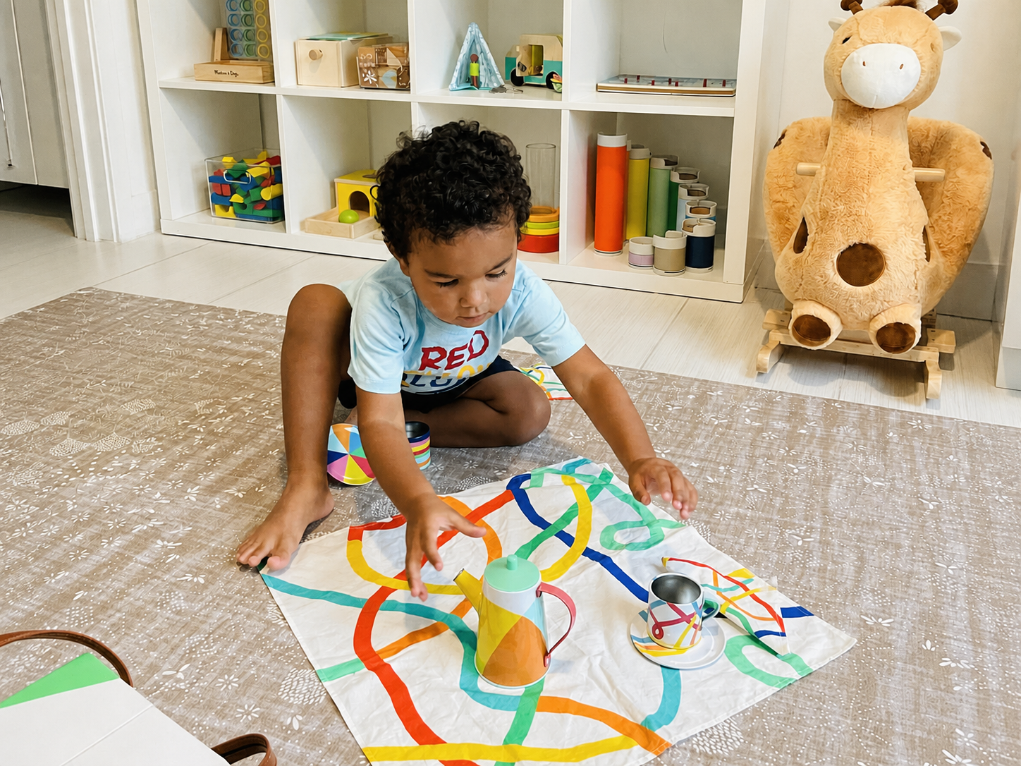 Toddler engaged in quiet play in an organized playroom
