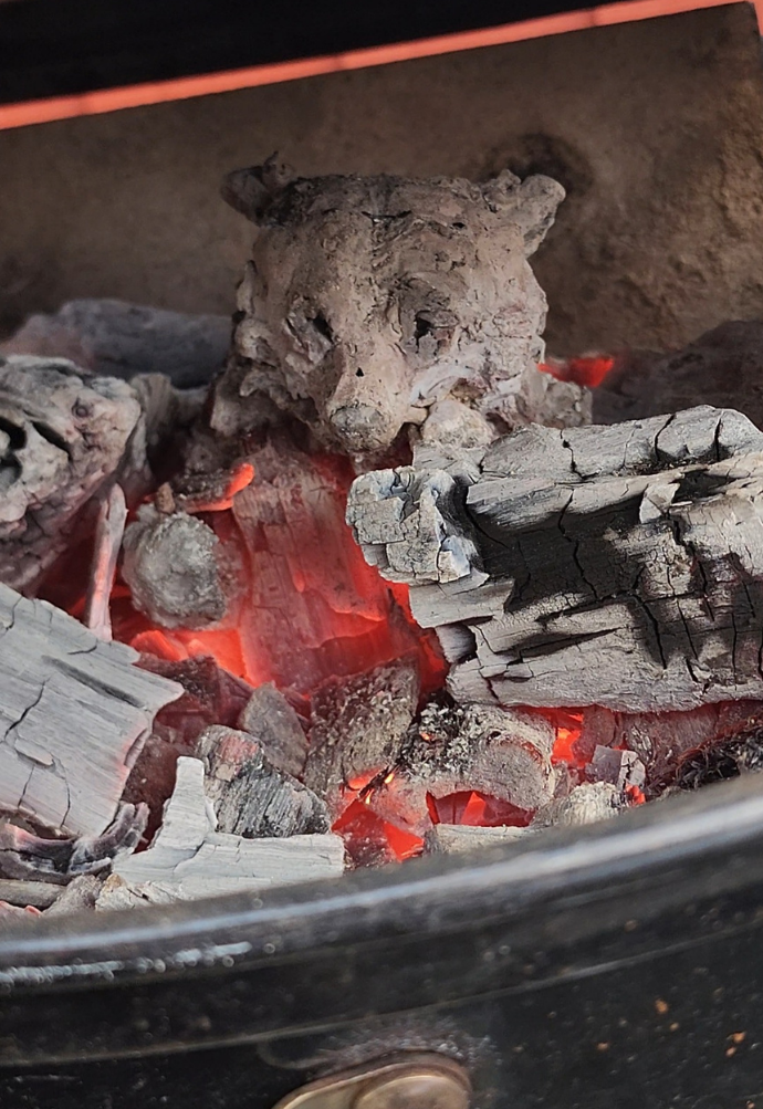 A burnished, smoke-fired vessel held in one hand