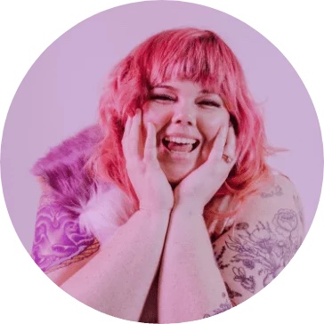 A joyful person with pink hair