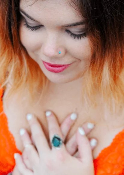 Image of person with their two hands on chest/heart