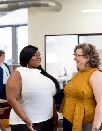 Two people in conversation at a Body Trust gathering
