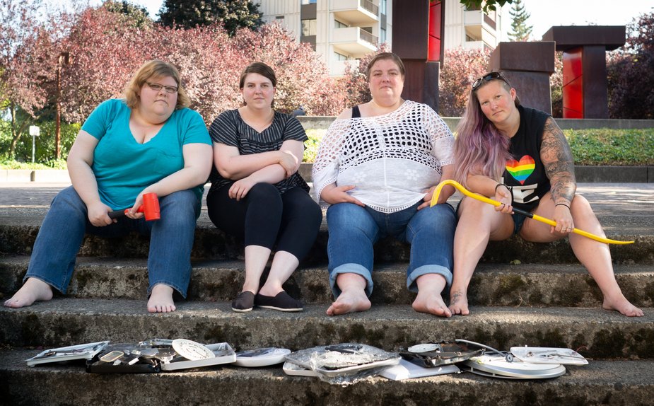 Image of 4 people with smashed scales on ground