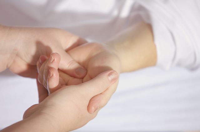 Hands performing Marma therapy