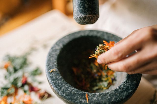 Traditional mortar and pestle with Ayurvedic herbs
