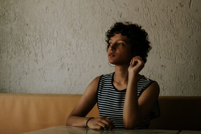 Woman reflecting by a window