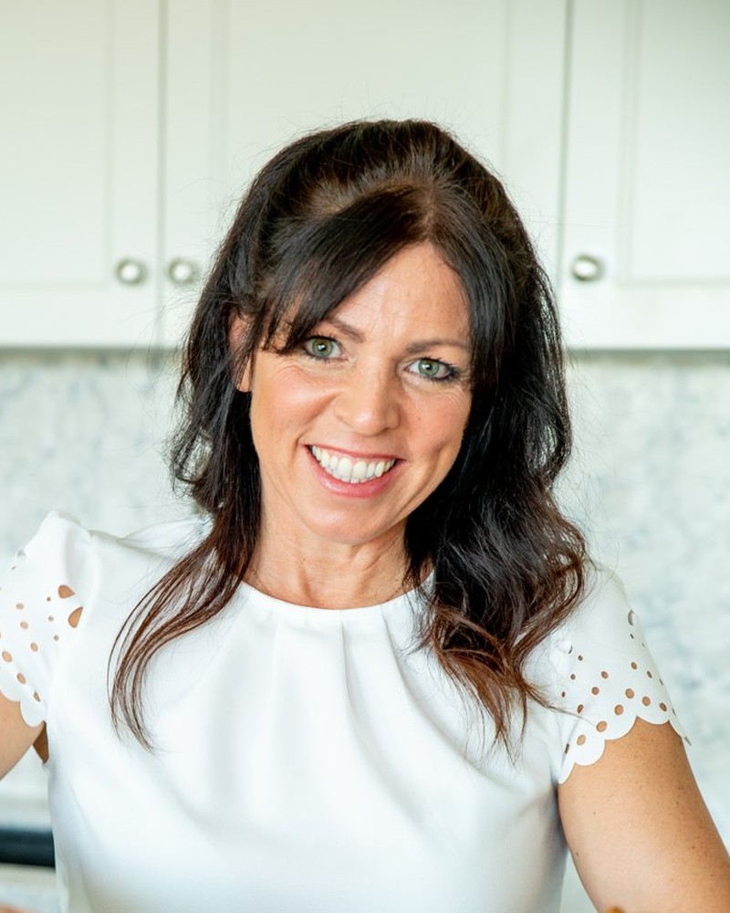 Amy Jones smiling in her kitchen