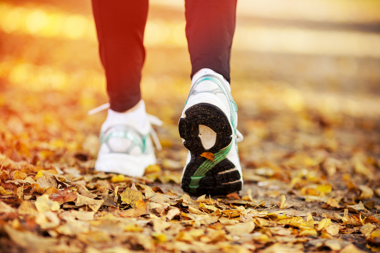 woman walking in leaves