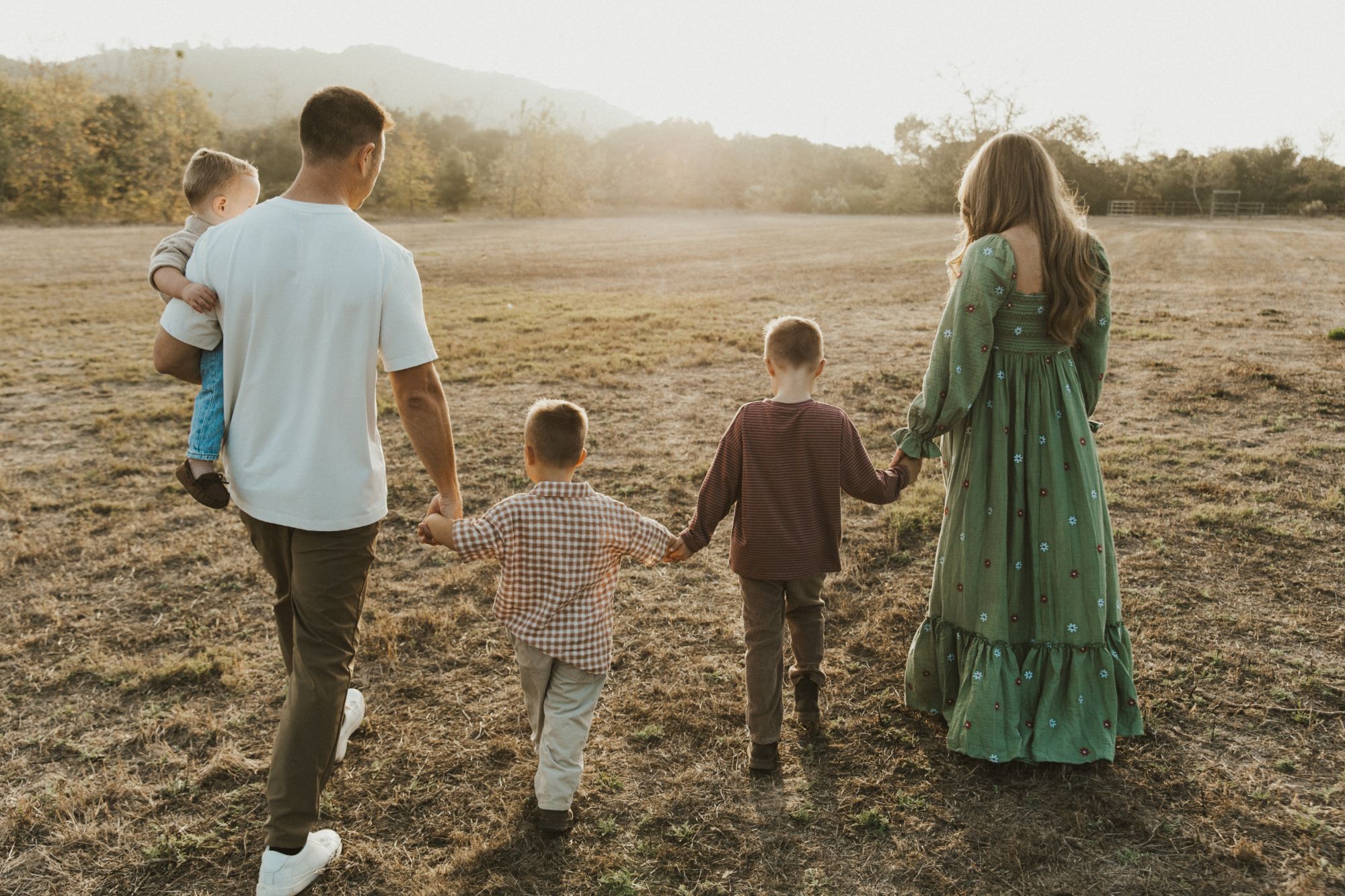 Ashley and her family walking together at sunset