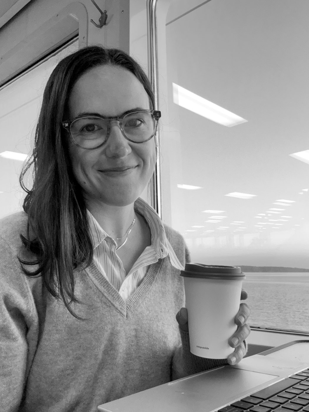 Allie Williams on the morning ferry, holding a coffee.