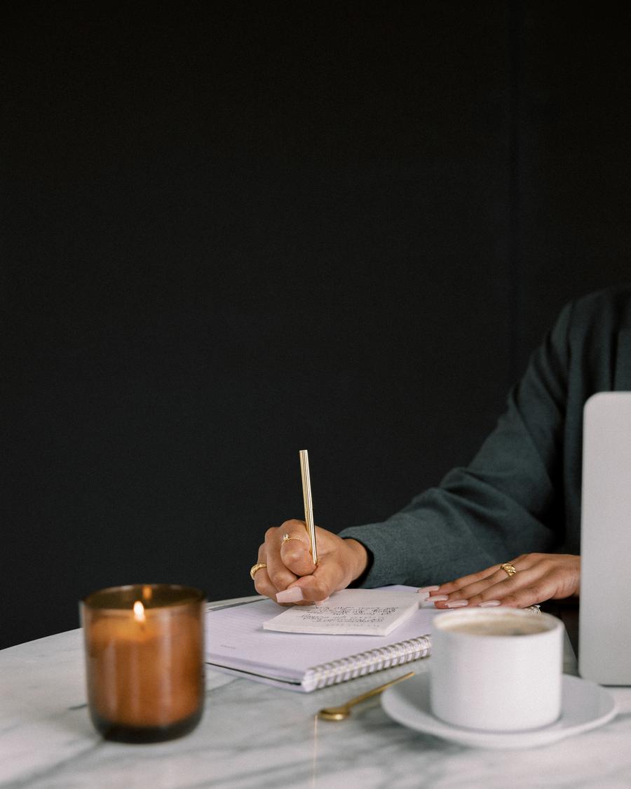 Writing out a client plan at a marble desk