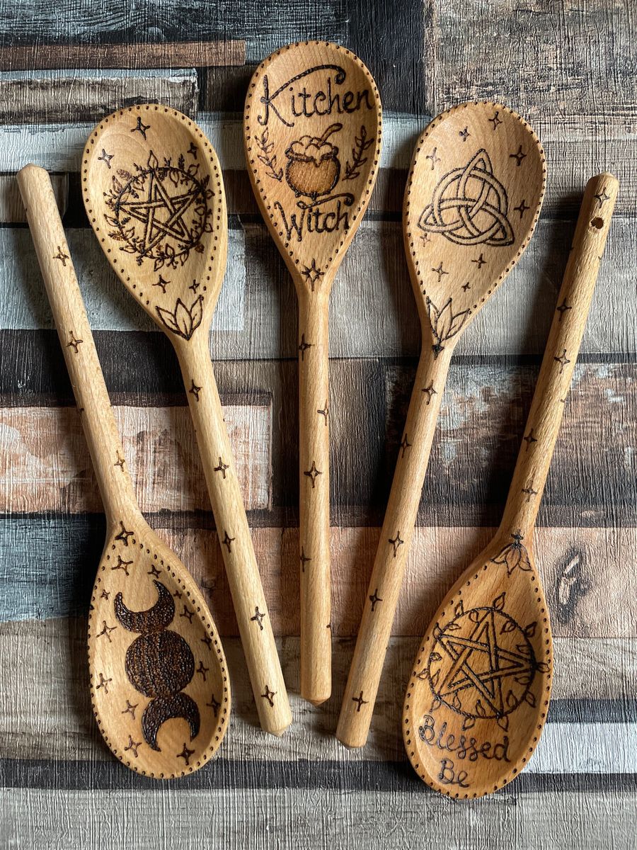 Original burned designs on wooden spoons: pentagram, triple moon, cauldron and triquetra