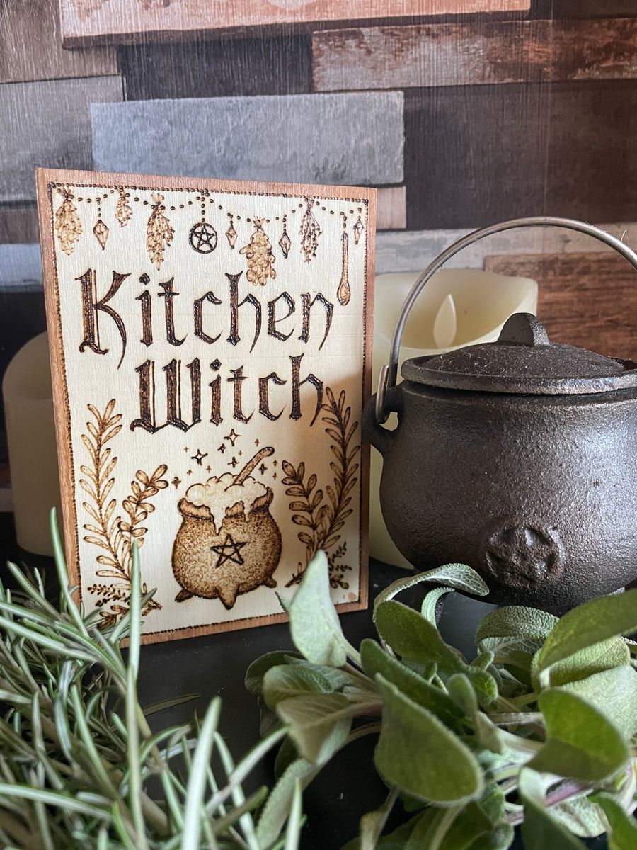 A finished Kitchen Witch wall sign