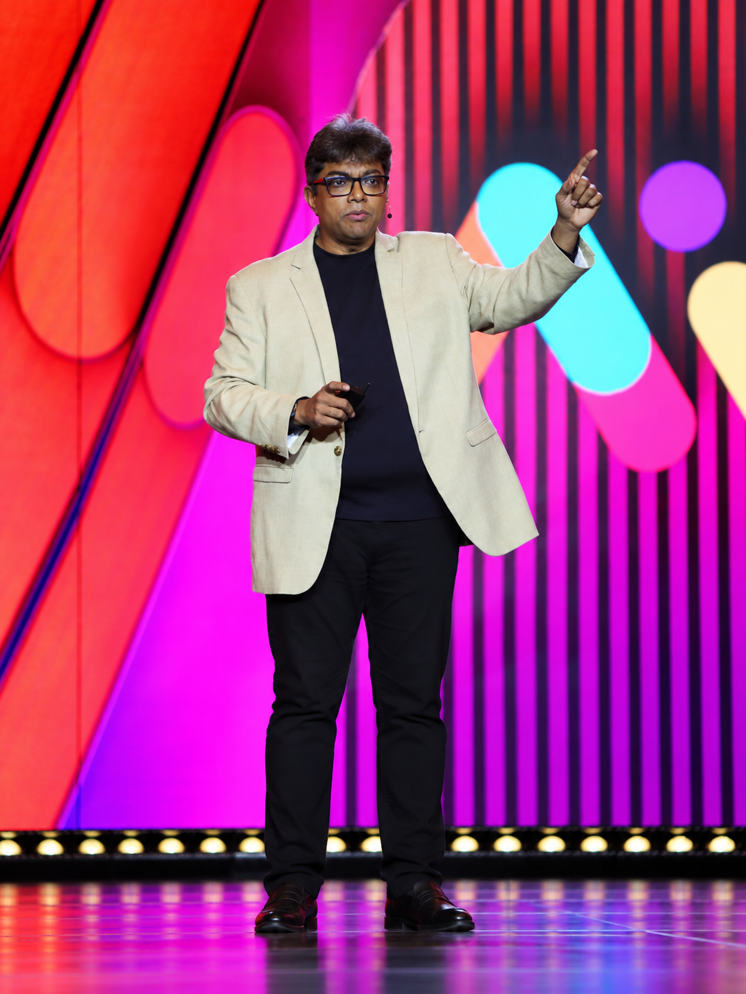 Natchi Lazarus giving a keynote on stage