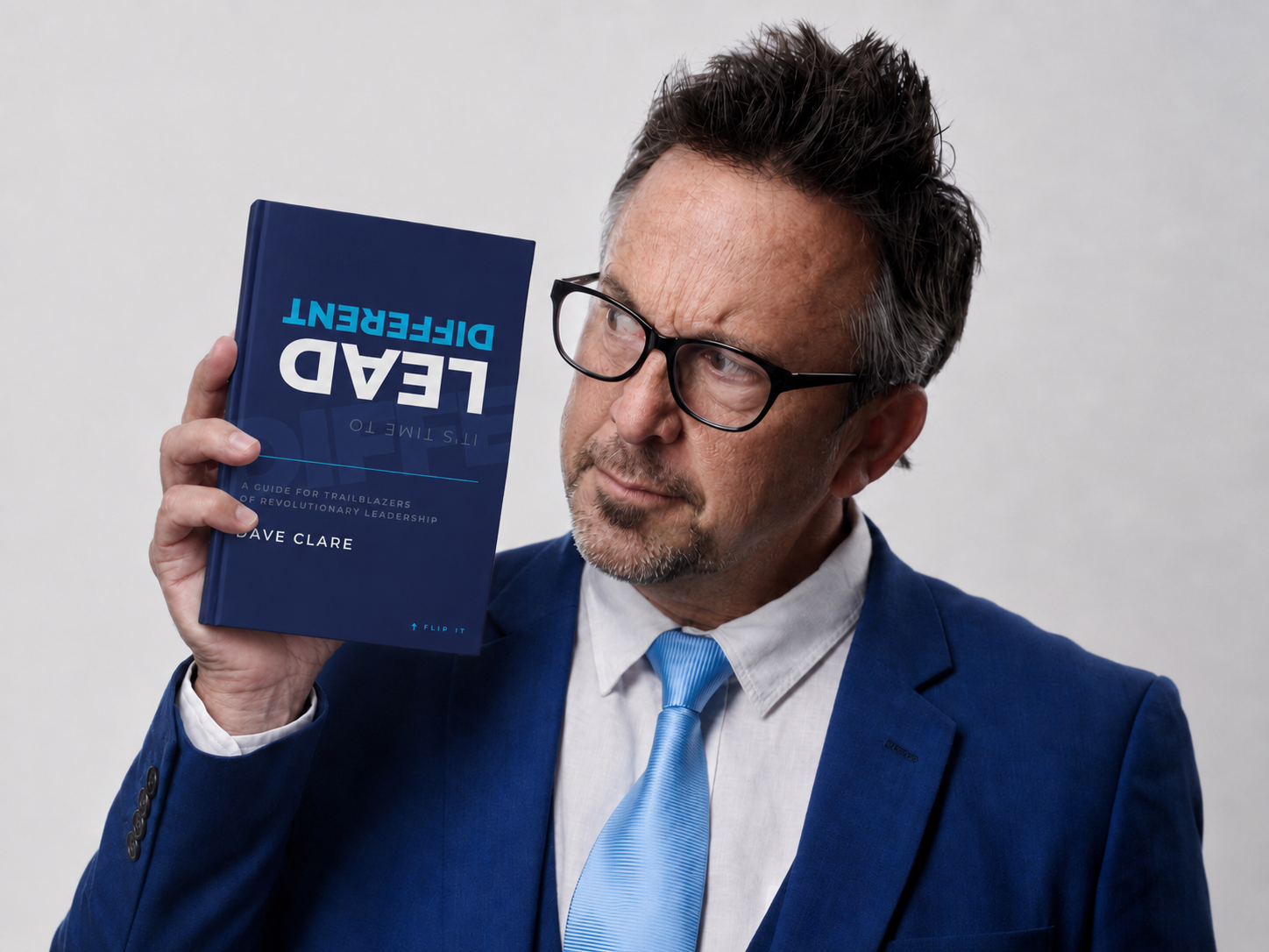 Dave Clare holding his book It's Time to Lead Different