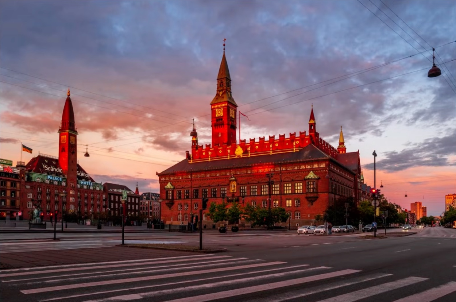 Copenhagen City Hall at dusk, with cables and wires crossing the entire sky