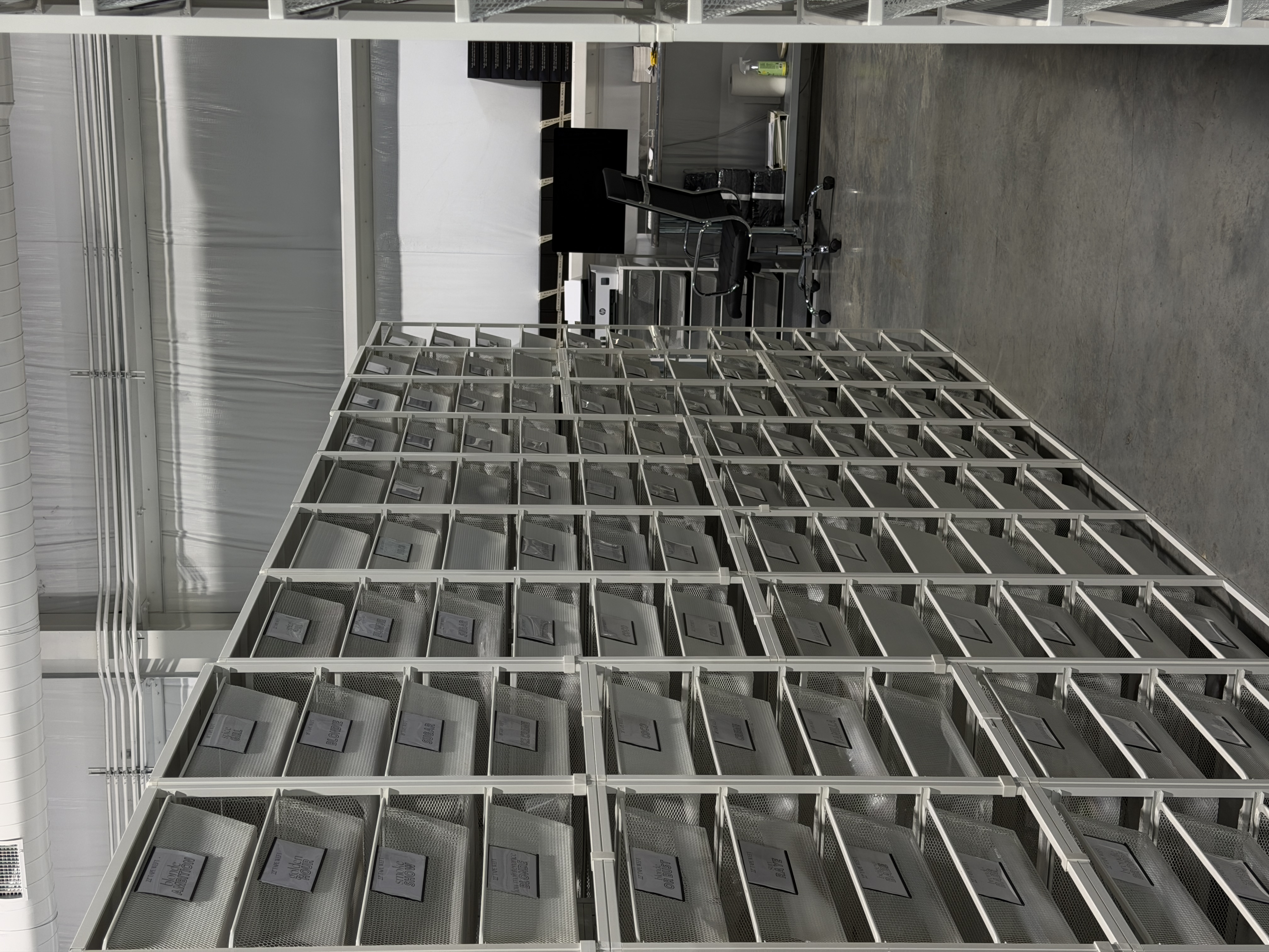 Wall of labeled shade bins inside the BYOB warehouse