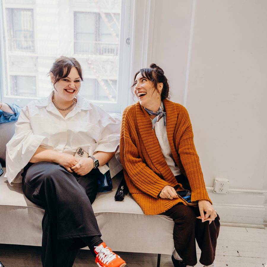 Two students laughing and talking at a DTH class
