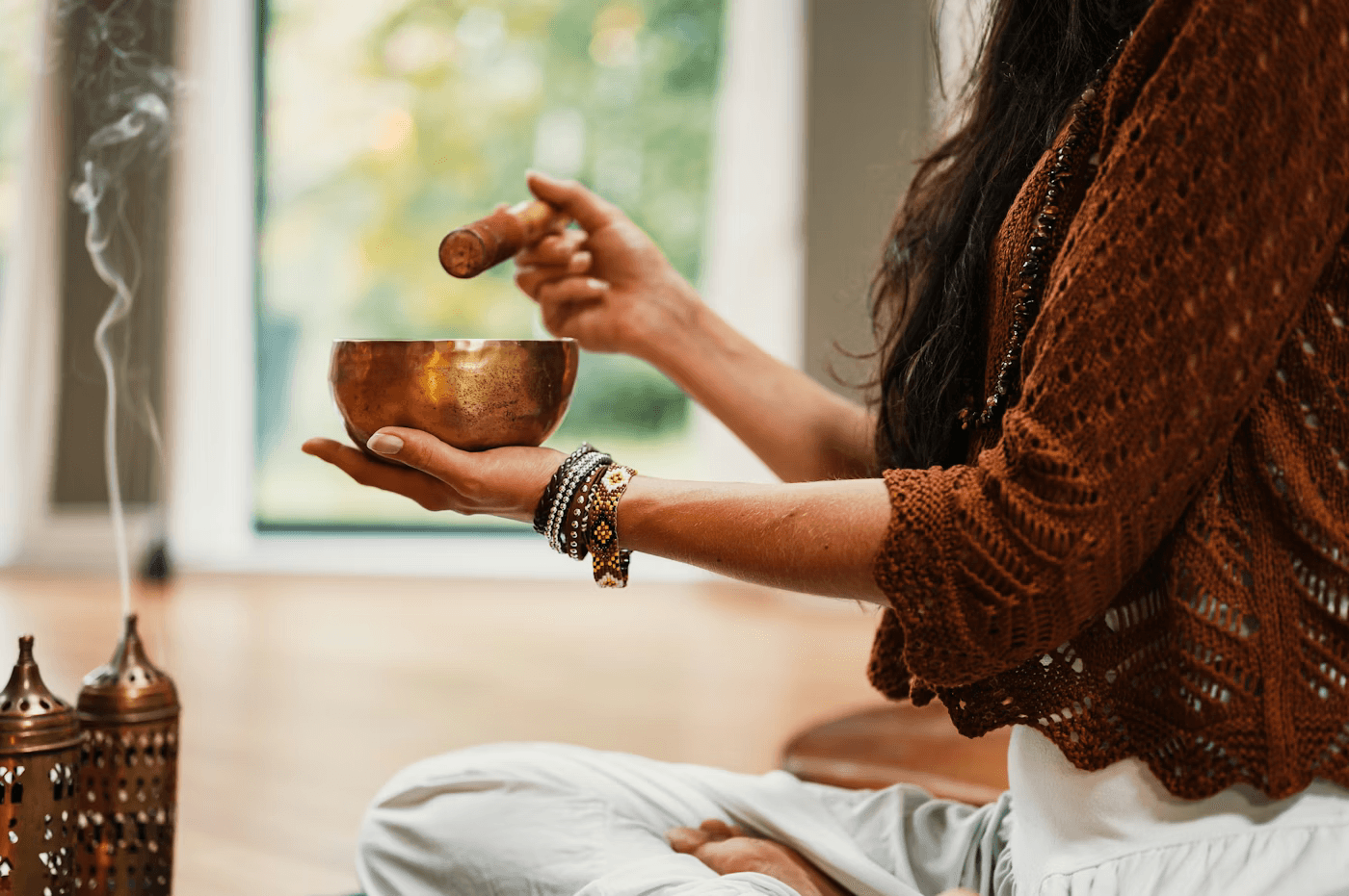 A practitioner with hands hovering over a client during a healing session