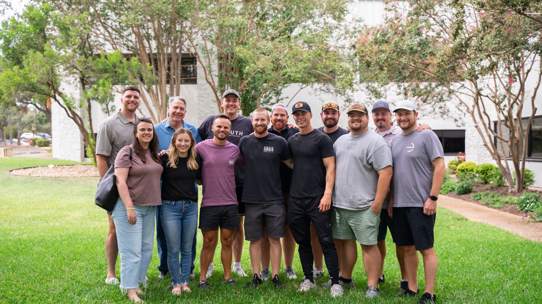 The Elementum team standing together outside, arms around each other.