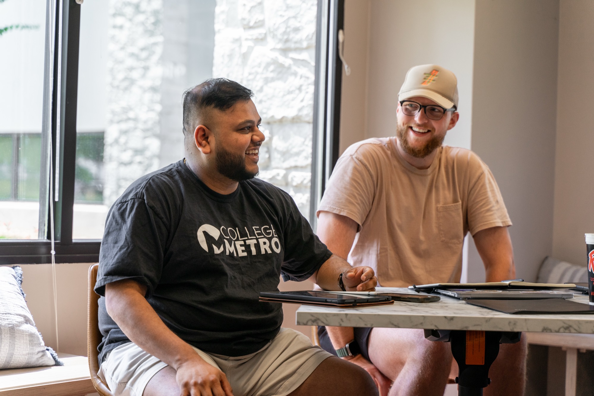 Two ministry leaders laughing together during a coaching conversation