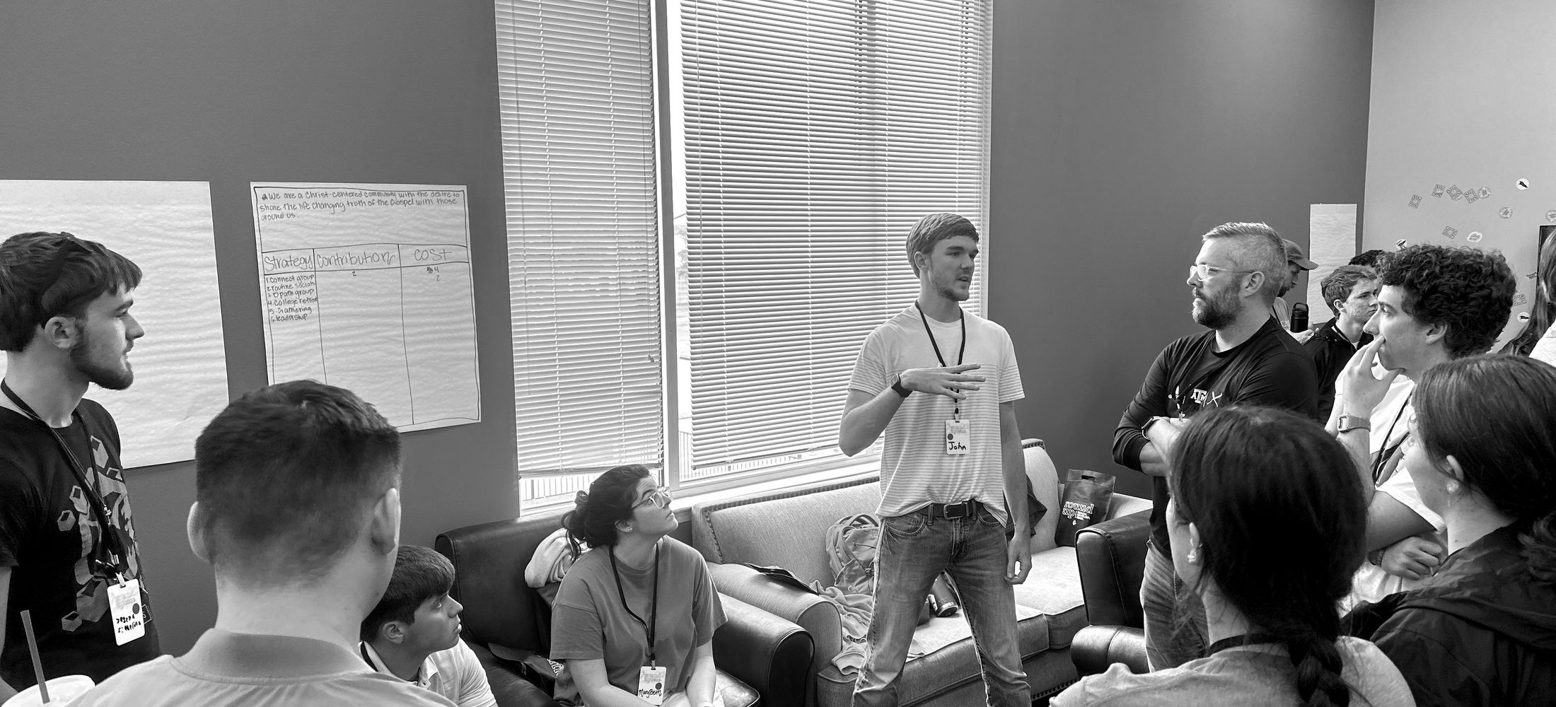 Young adult leaders gathered in a room, talking together