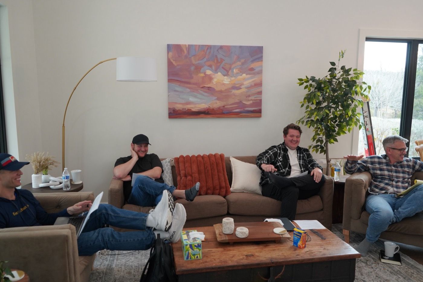 Leaders laughing together on the couch