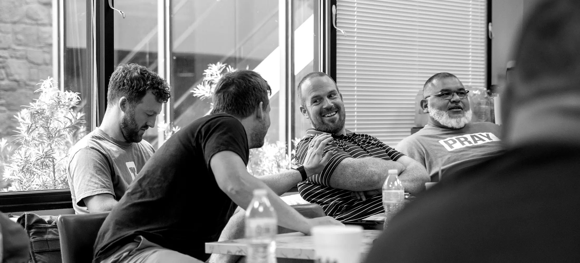 Ministry leaders talking and laughing around a table